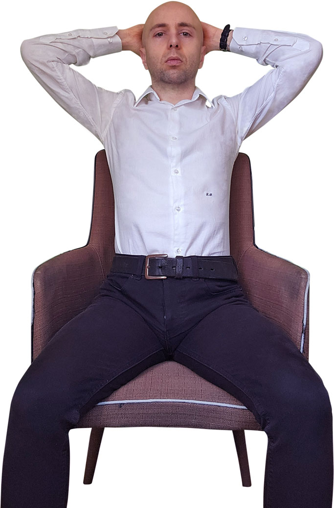 masculine body language but overdoing the 'manspreading' with legs too far apart