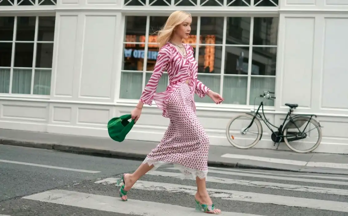 a beautiful and stylish transngender woman walking in a clean urban street