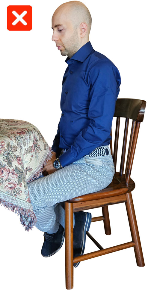 man by a table with low confidece nonverbals