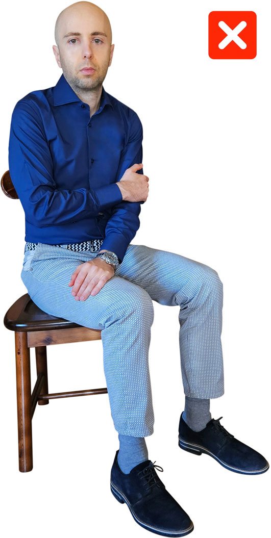 man with low confidence body language pose while sitting