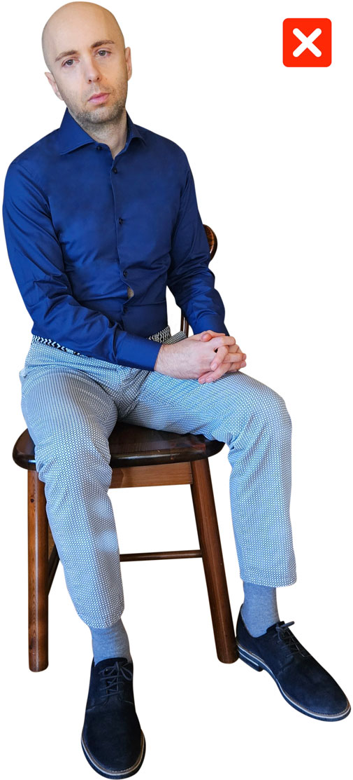 man sitting while displaying low confidence body language